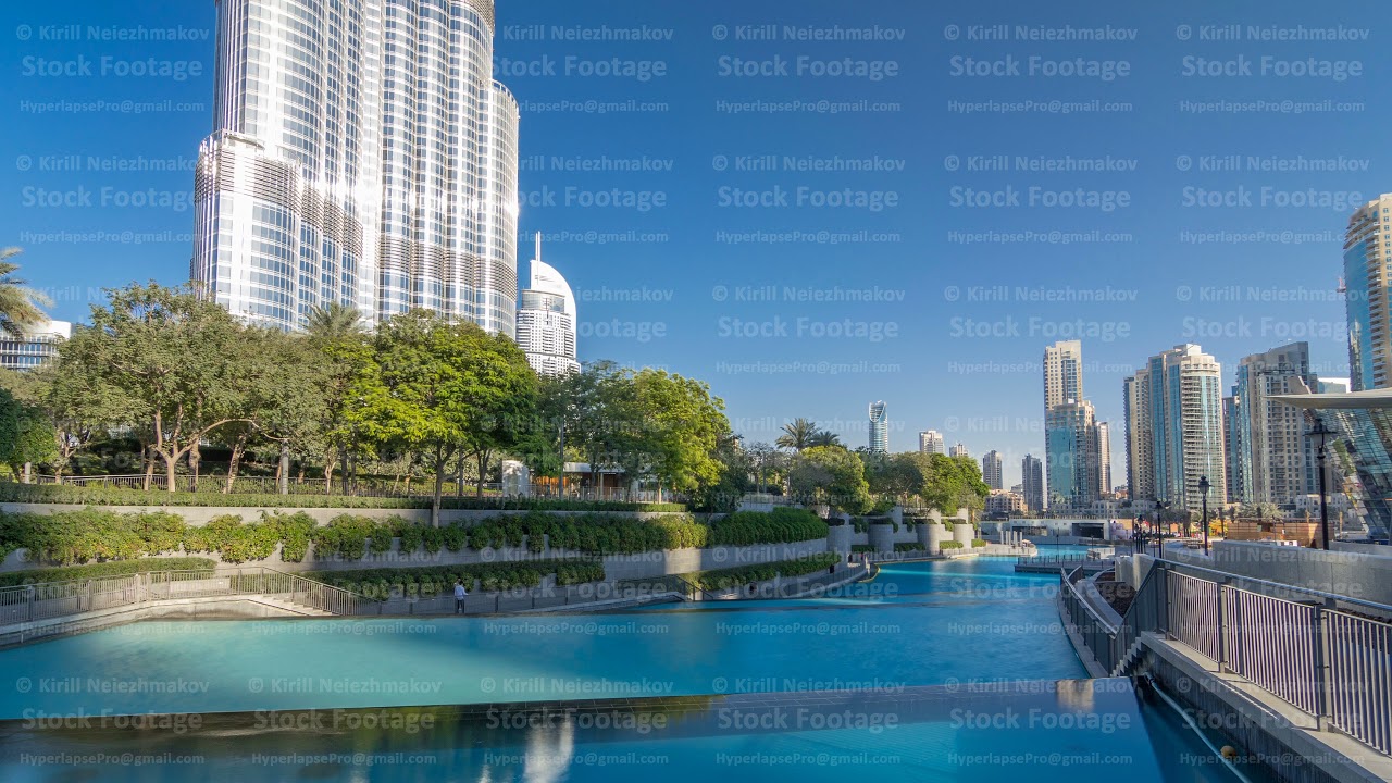 Evening view of cascade of water near dancing fountains in downtown timelapse in Dubai, UAE.
