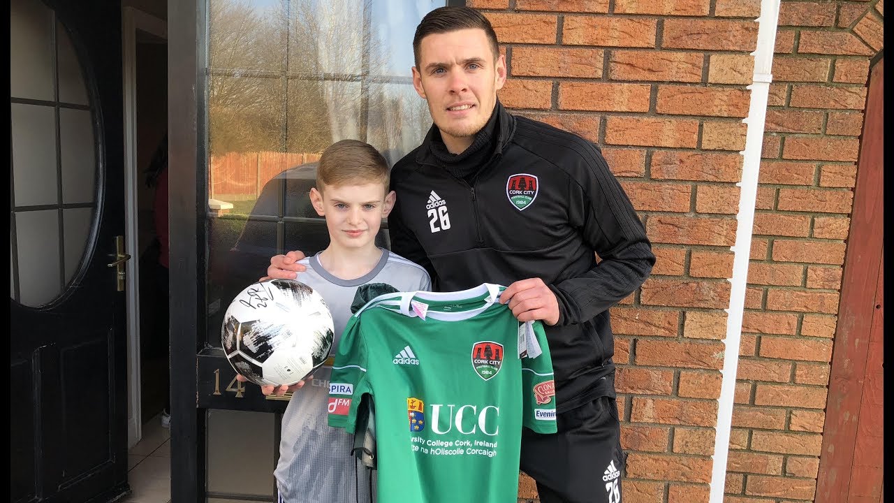Garry Buckley presents a lucky CCFC fan Darragh with his new 2018 home shirt