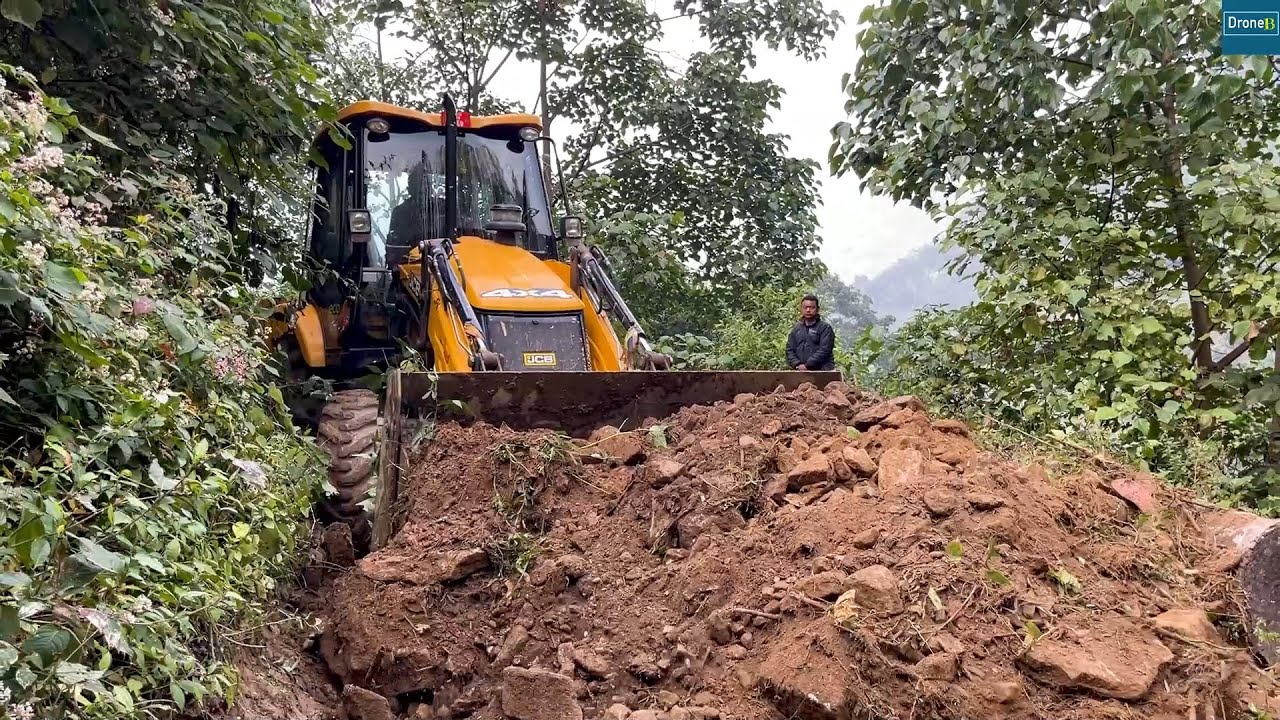Leveling Narrow Road Through Dense Mountain Forest with JCB Backhoe