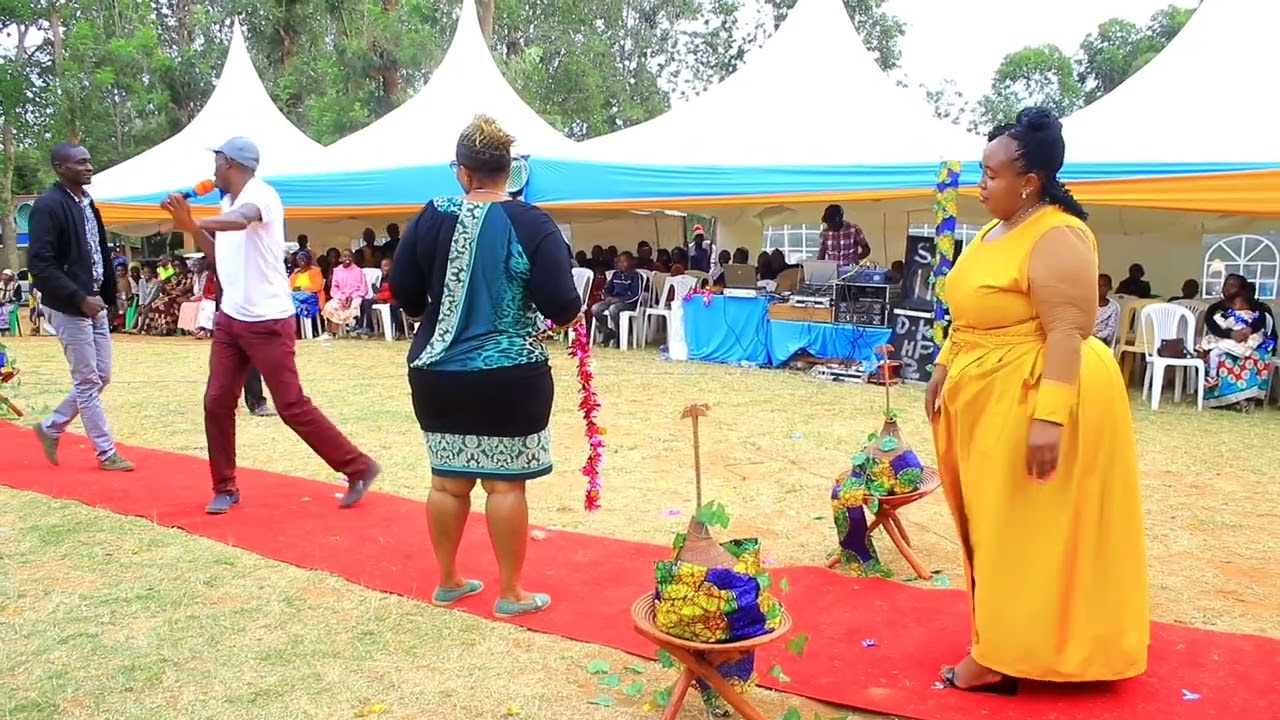 Switmaggy dancing with the bride at a dowry payment event in Kangundo