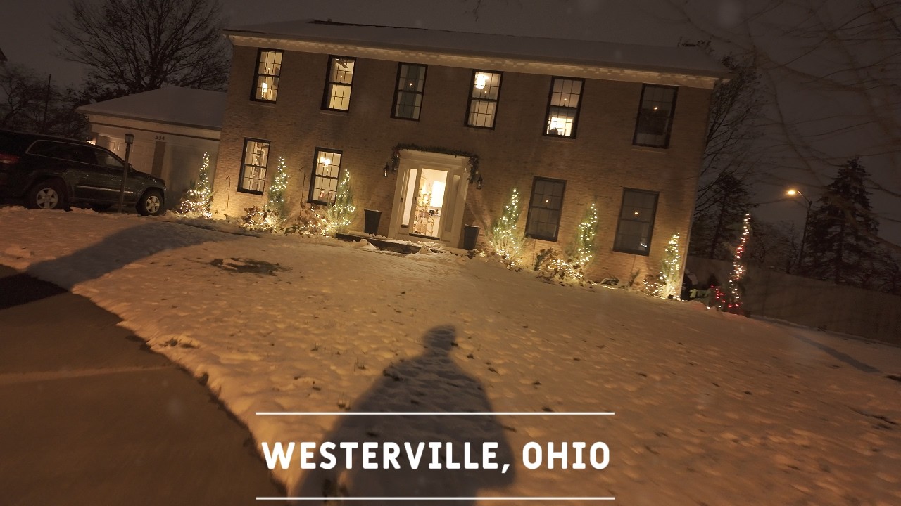 A peaceful nighttime walk surrounded by glowing Christmas lights.
