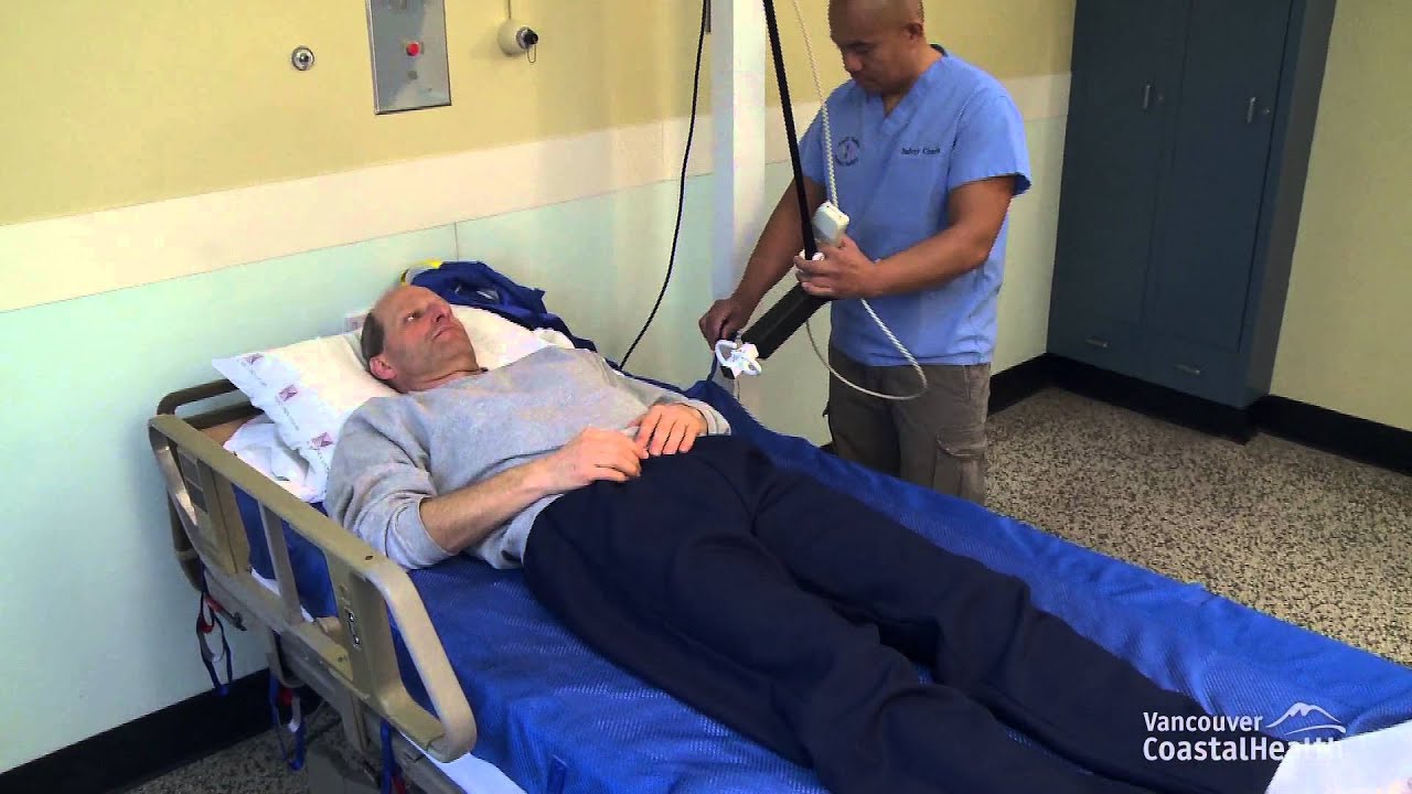 MSIP - Using a ceiling lift to place the transfer sling under a lying patient