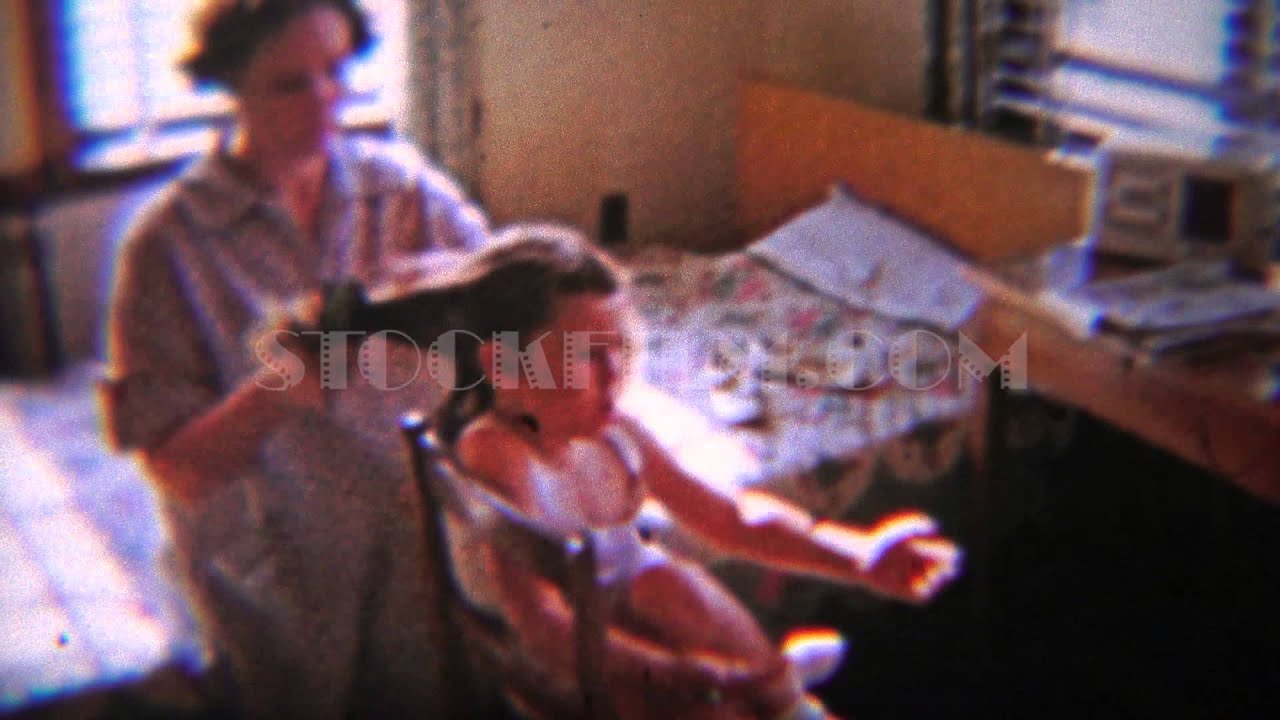 1954: Impatience mom brushing girls hair modest kids bedroom.  DAYTON, OHIO
