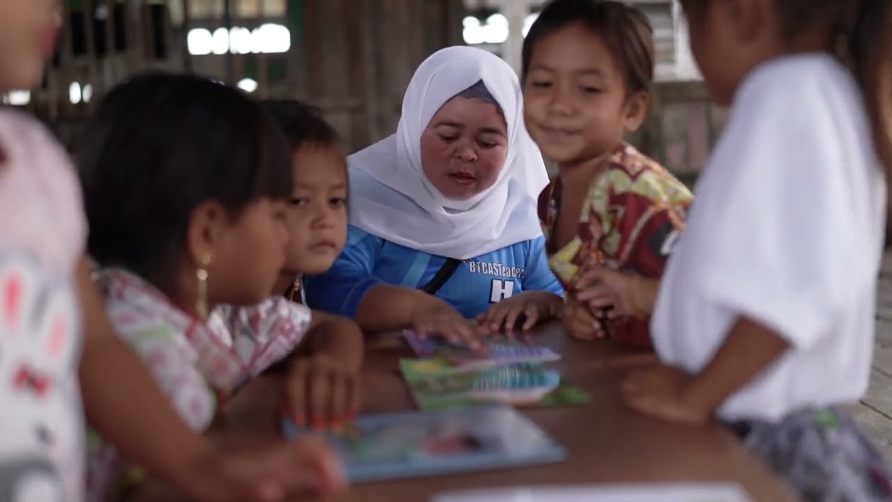 Children holding books for the first time.