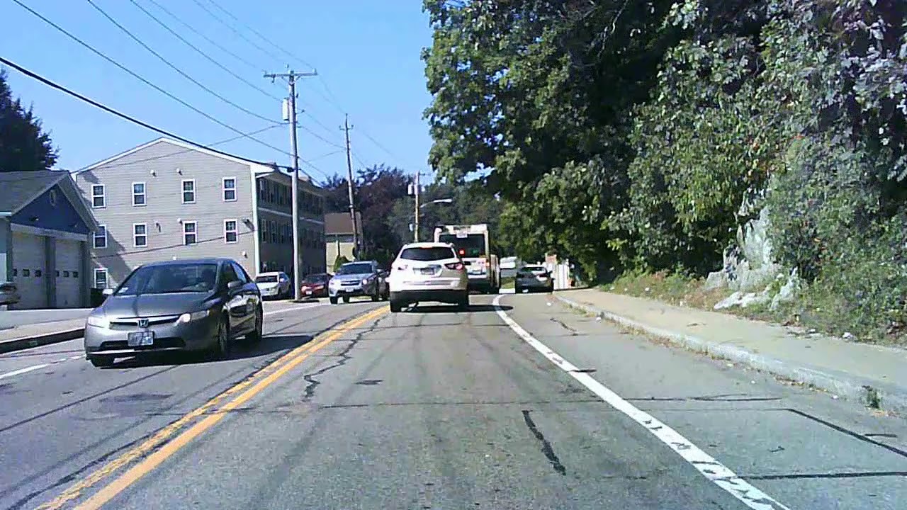 Car passing RIPTA bus on Plainfield Street in Johnston, Rhode Island