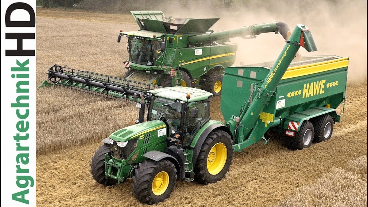Tractors of John Deere New Holland with the HAWE grain cart | Claas combines | Farming