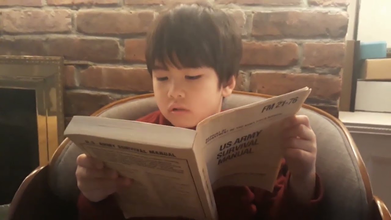 gael reading army survival manual at 3 years