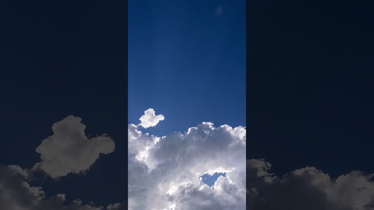 Stock Video - Time lapse of clouds moving as sun rays shine through