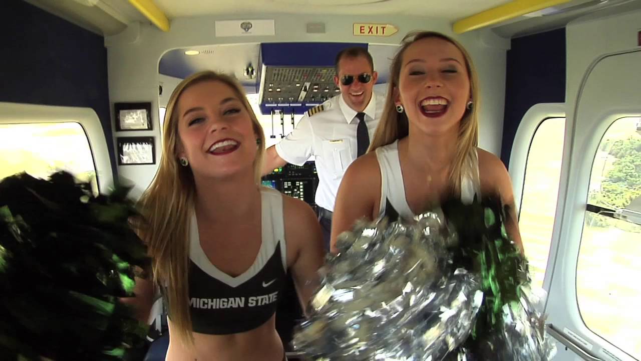 Alabama and Michigan State cheerleaders play cornhole from the Goodyear blimp