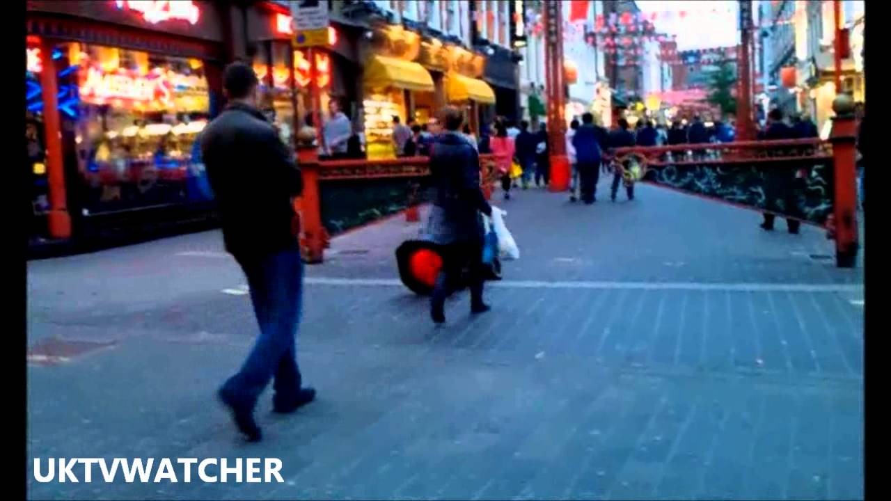 Funny tramp playing traffic cone as trumpet