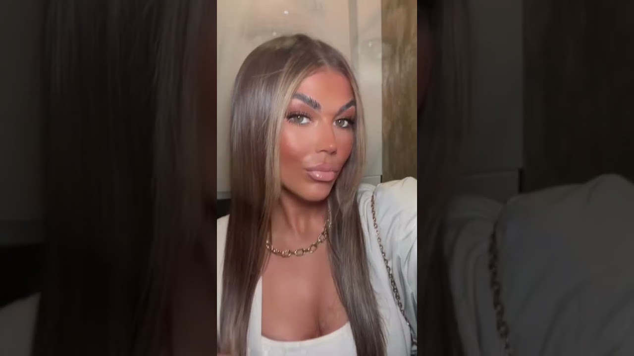 Confident and Stylish Female Vlogger Self-Recording a Video.