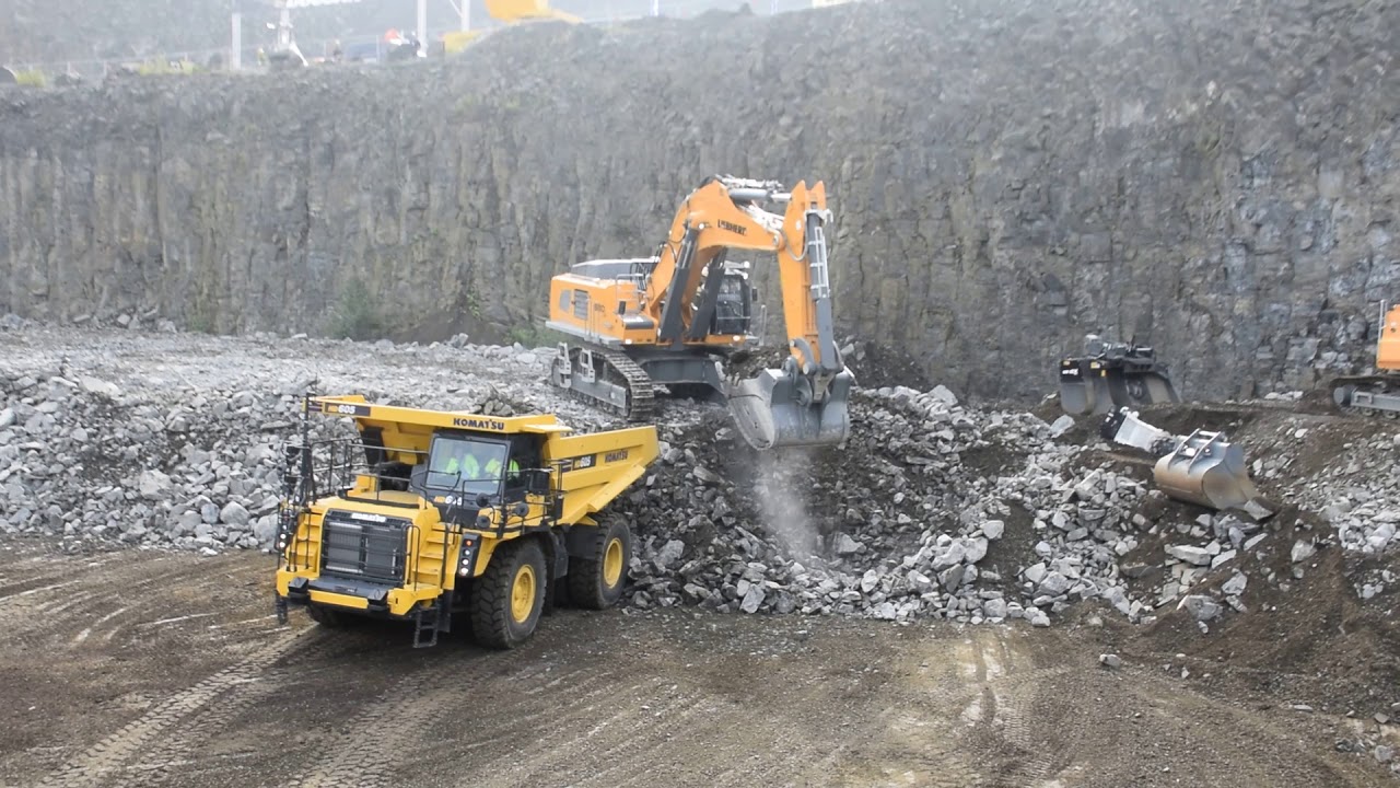 Liebherr R980 SME excavator loads Komatsu HD 605-8 dumptruck