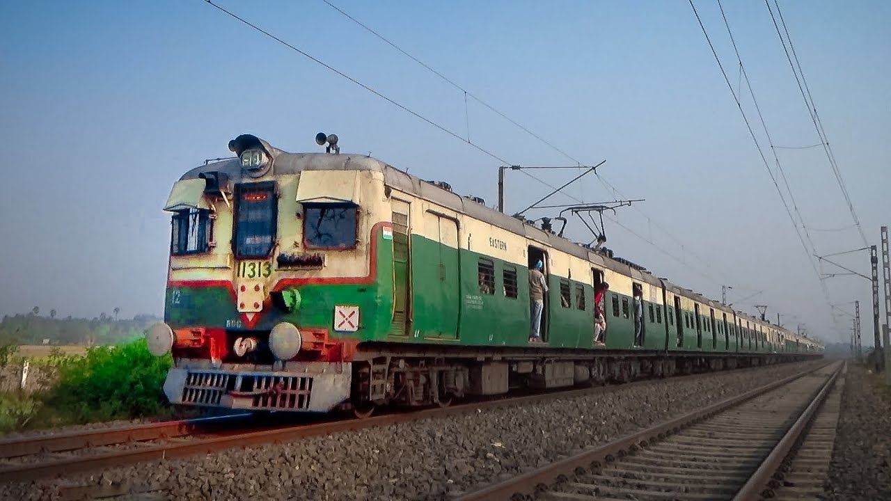High speed old model vintage green color crowded EMU local trains of Eastern Railway