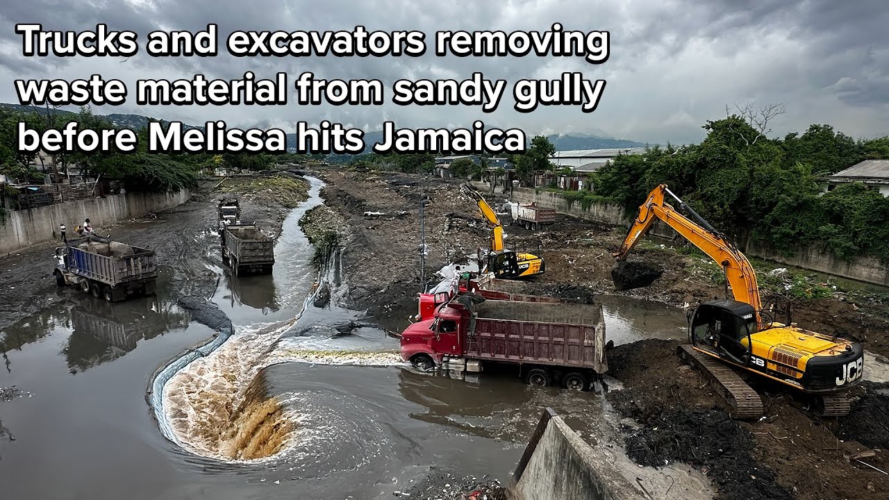 Trucks and excavators removing waste material from sandy gully before Melissa hits Jamaica 🇯🇲