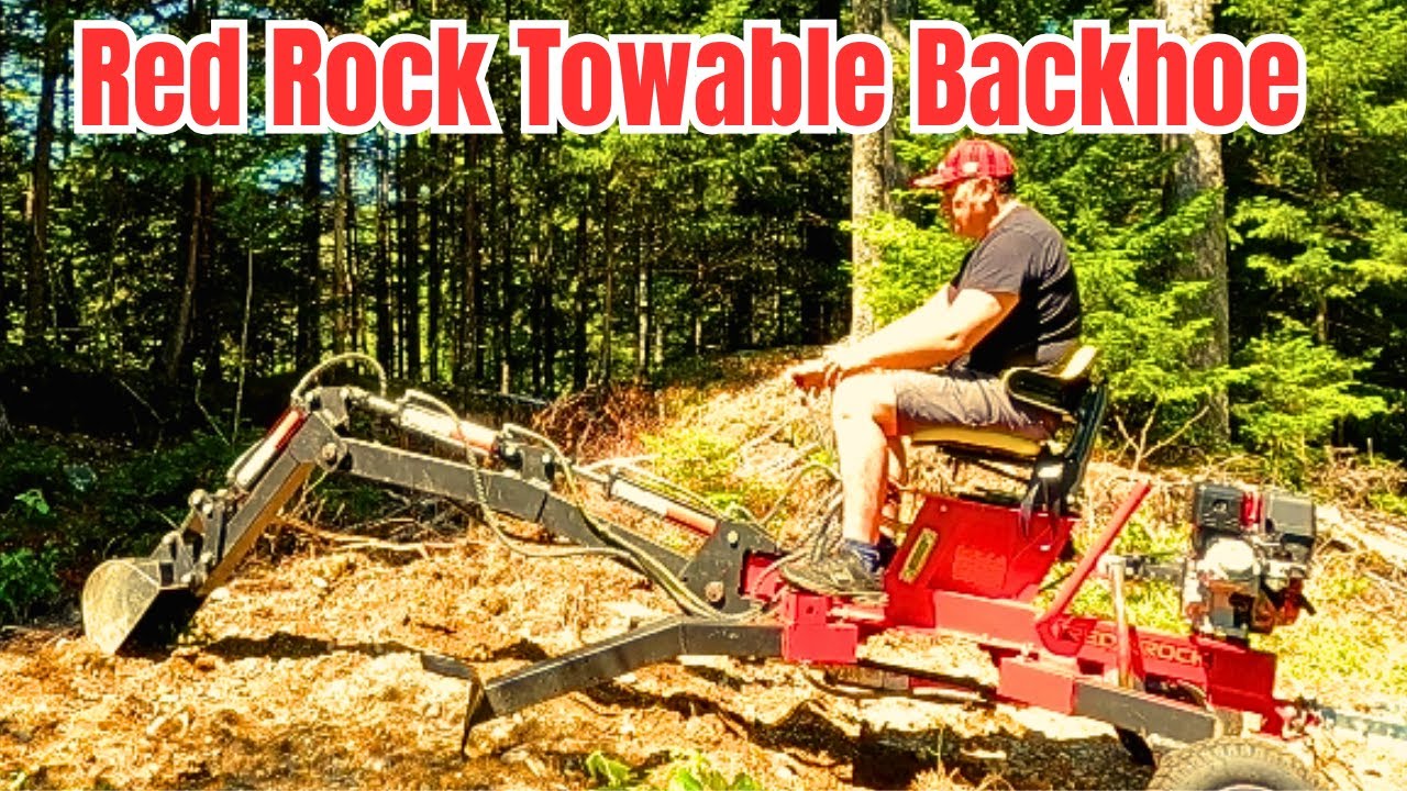 Red Rock /Trencherman Towable Backhoe from Princess Auto moving GRAVEL