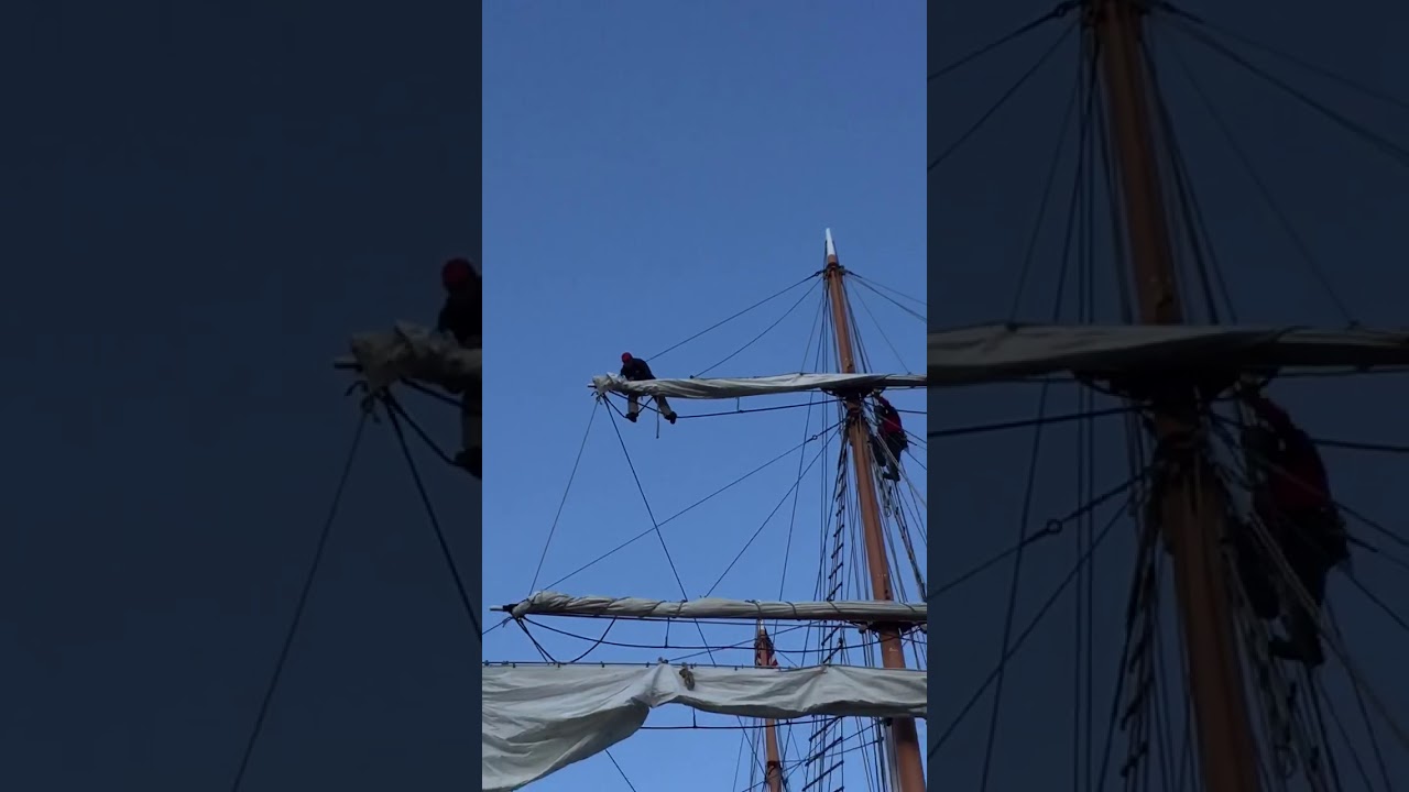 Folding the sail on the Top Gallant