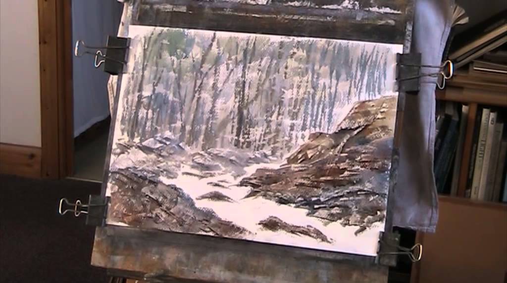 Painting rocks with a plastic card in watercolour
