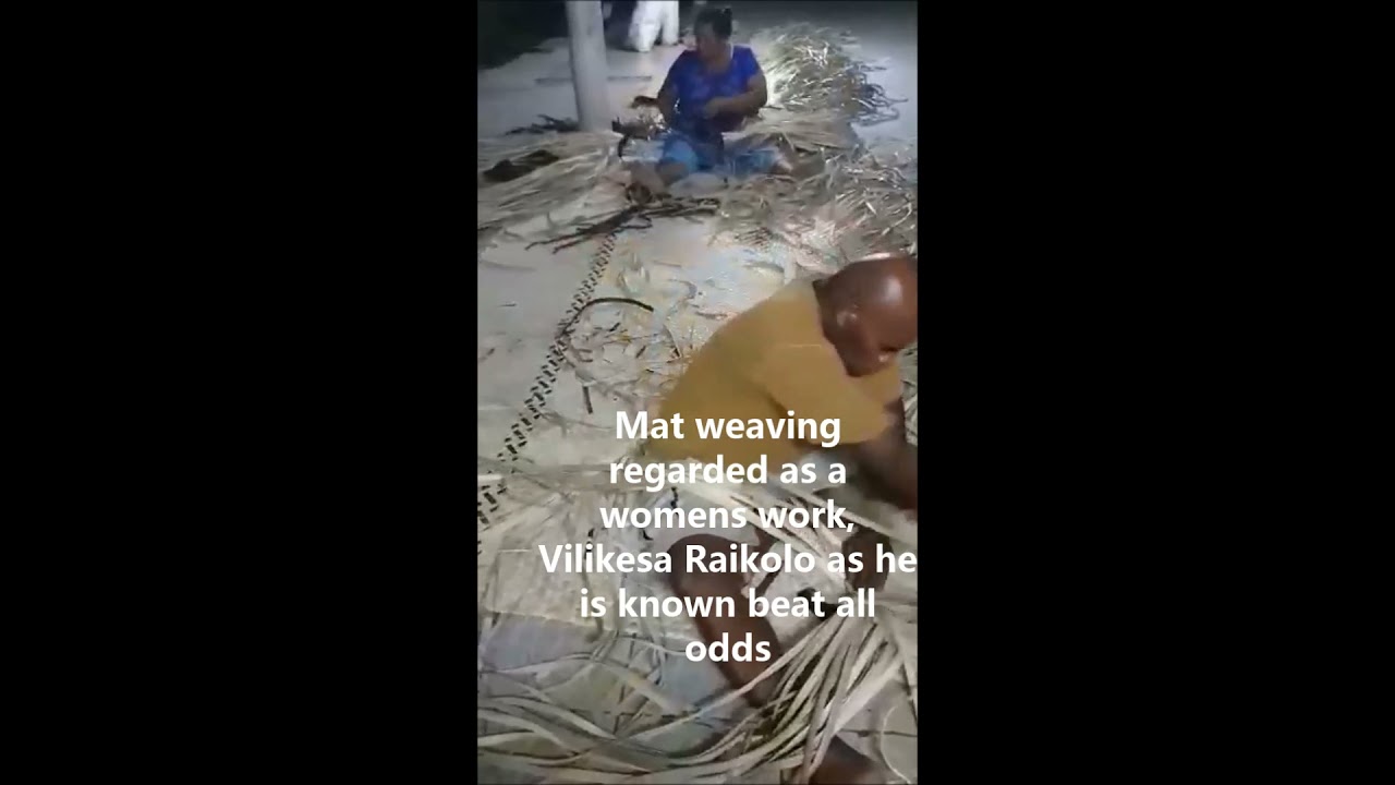 Fijian man weaving mat