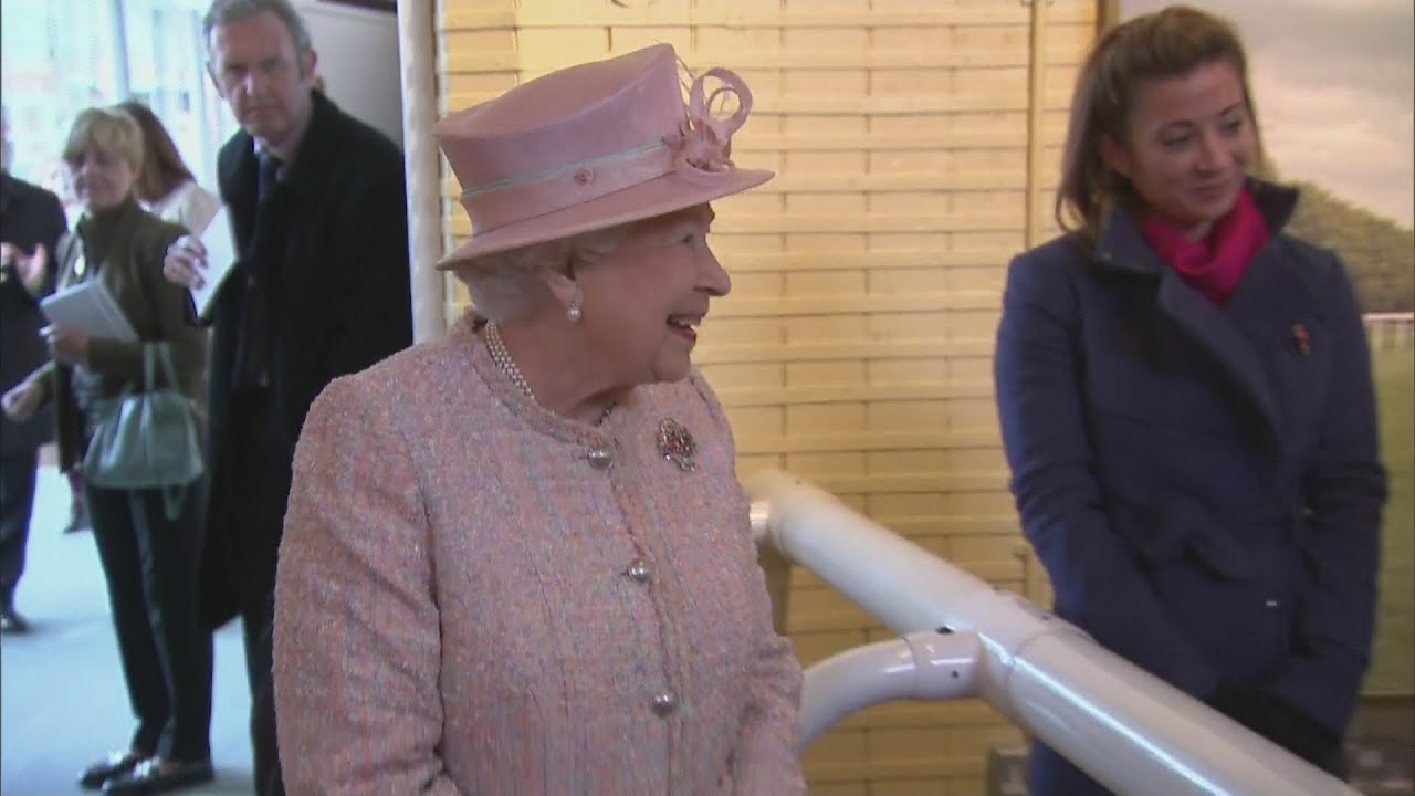 Queen amused by jockey on mechanical horse