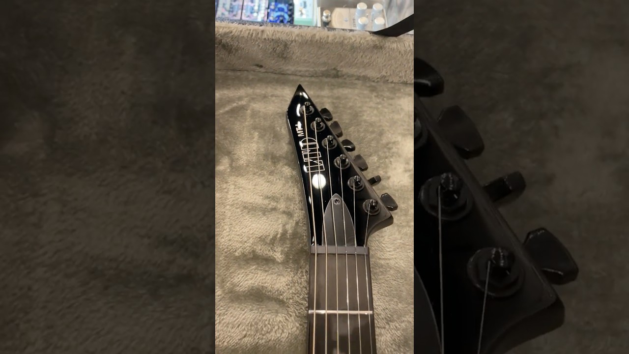 Unclasping an ESP LTD MT-I Mick Thomson Signature Electric Guitar