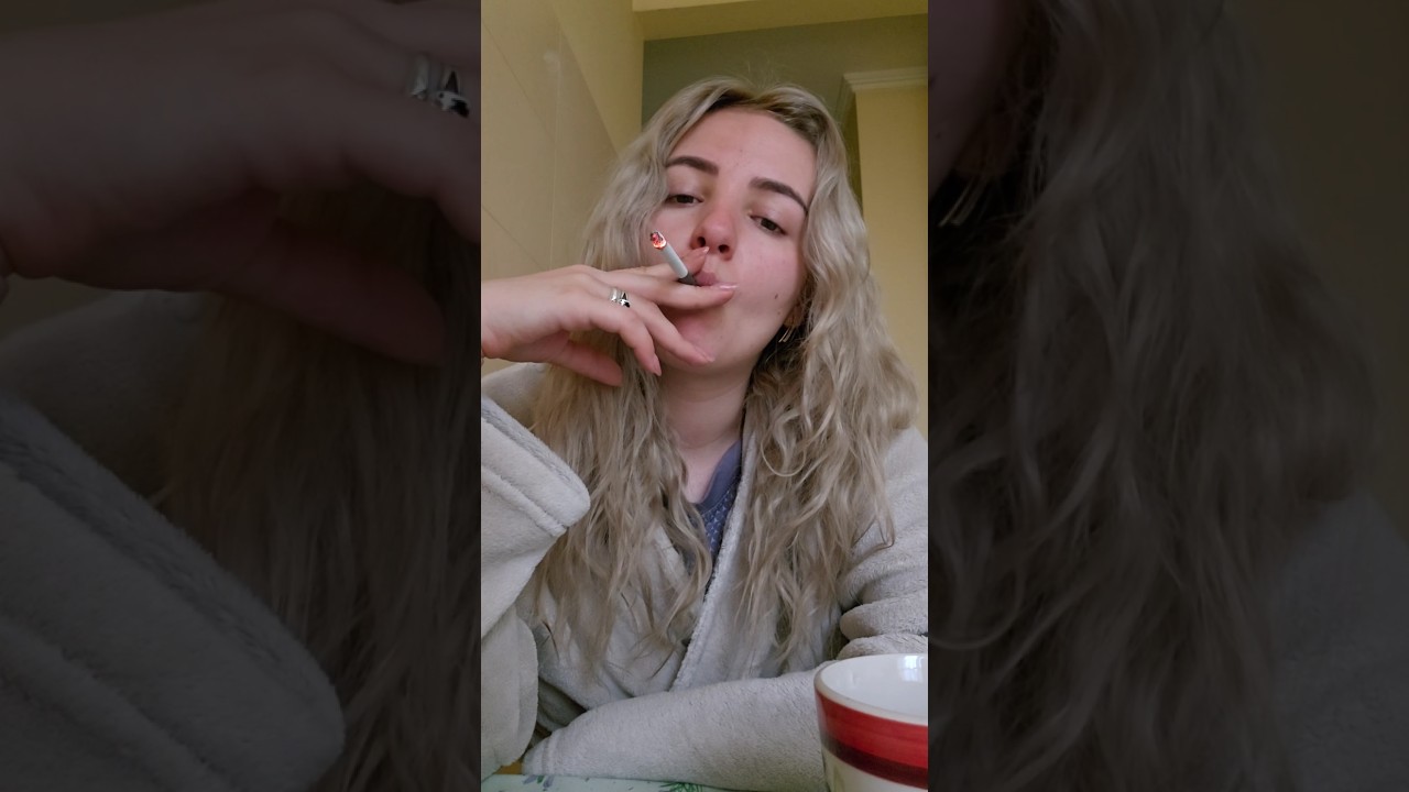 Girl smoking her first cig of the day with cofee