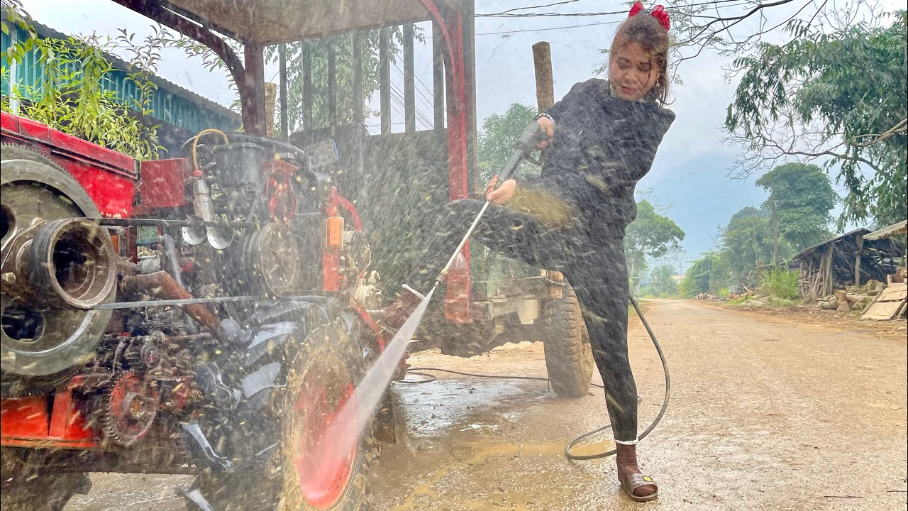 A female mechanic repairs a tractor engine with a leaking gasket.