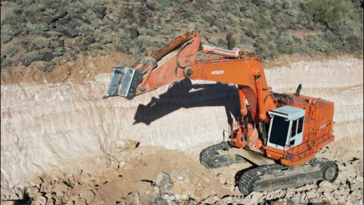 Massive excavator, ripping hard ground. Results speak for themselves. TopHatEarthworks.com