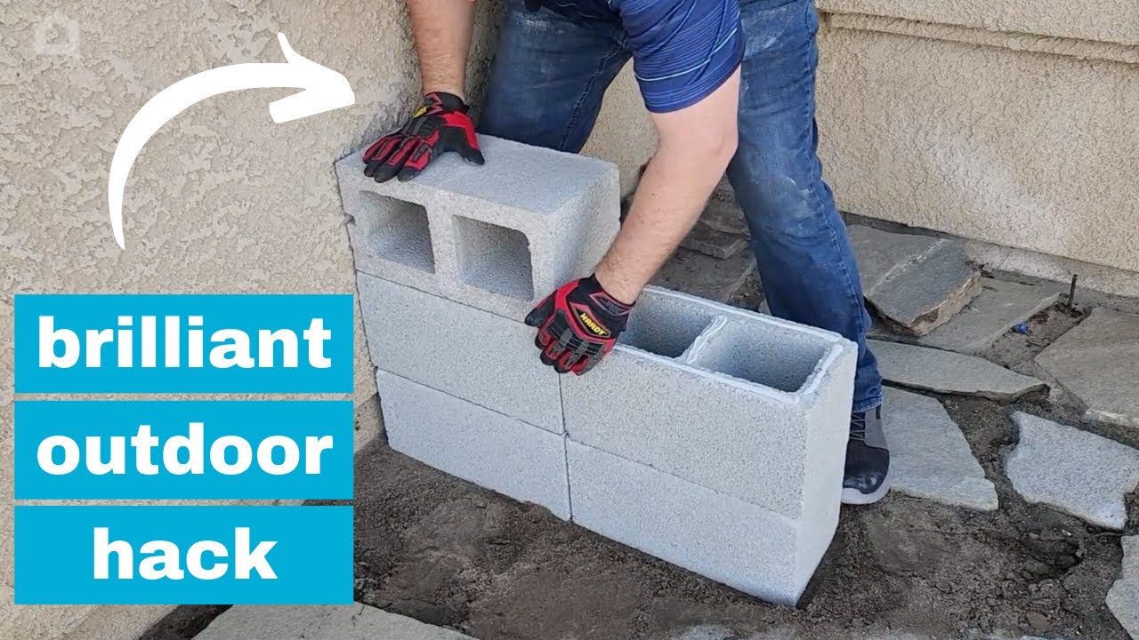He stacks cinder blocks in his front yard for a brilliant outdoor furniture idea!