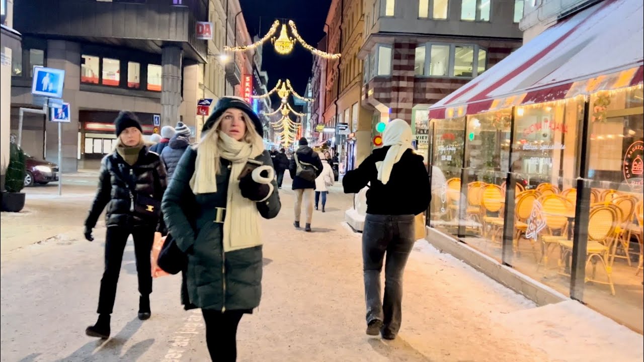 Walk through central Stockholm and Old Town. Snow, festive lights, people & sounds of the city