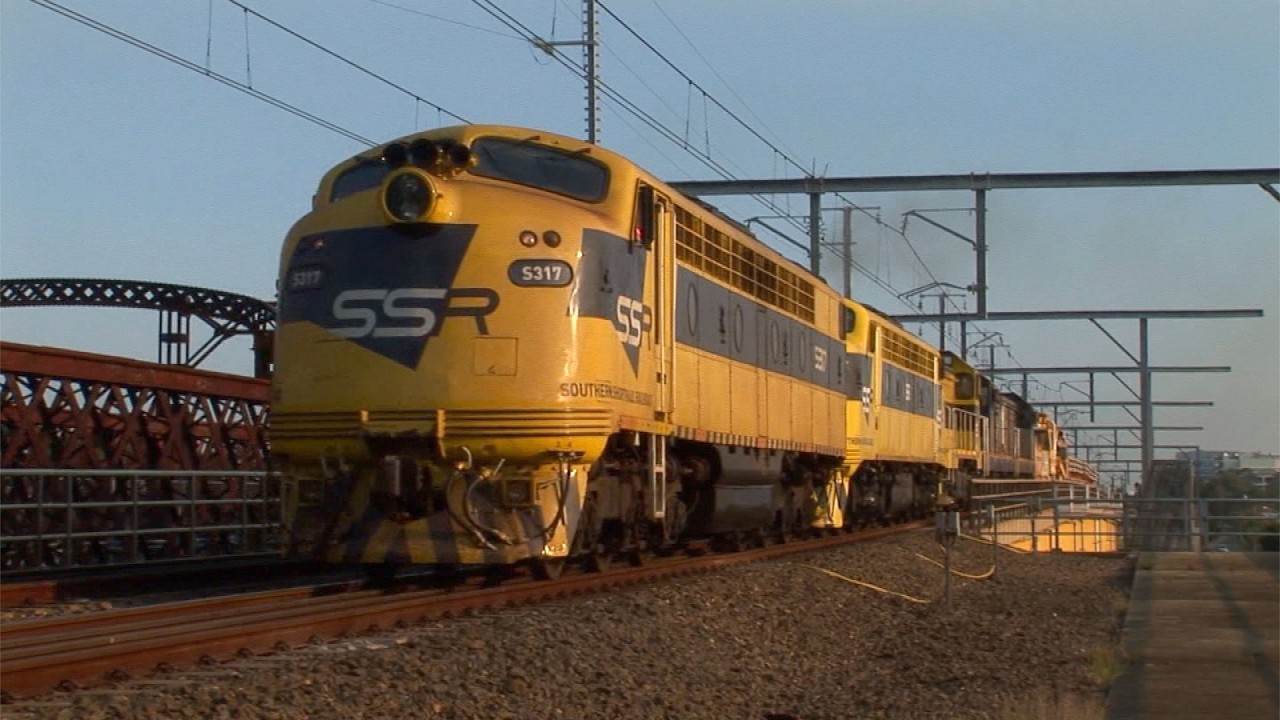 A variety of Australian diesel locomotives hauling maintenance trains out of Chullora - March 2006