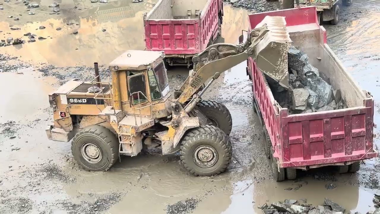Raw Power in Action 💪Watch the Caterpillar 966F loading massive rocks with precision and strength.