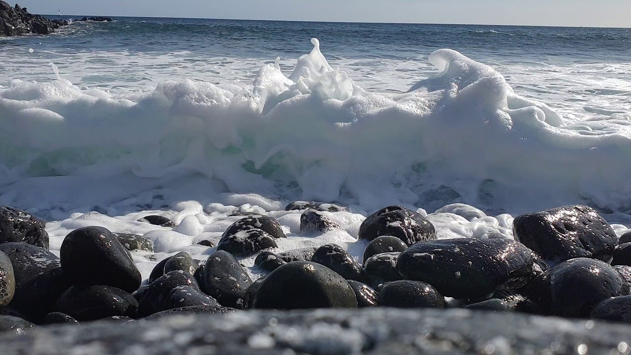 Waves crashing onto pebble beach . same beach as seen on crossfire.