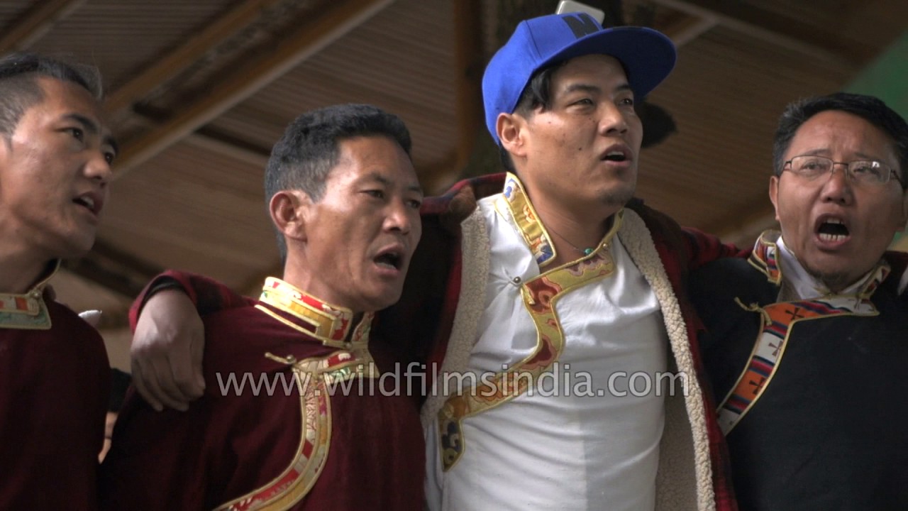 Tibetan men and women dance during Losar Festival | Dalai Lama Temple
