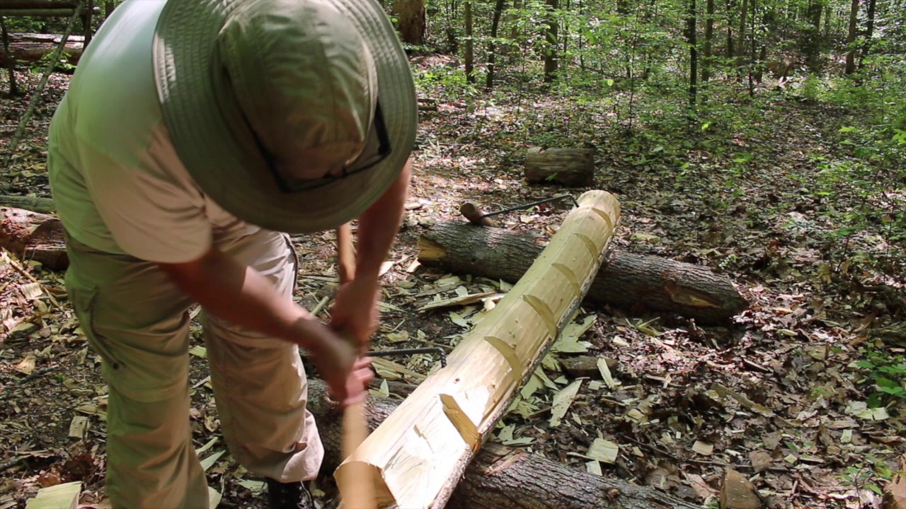 Ax Hewing a Log at Fixed Camp