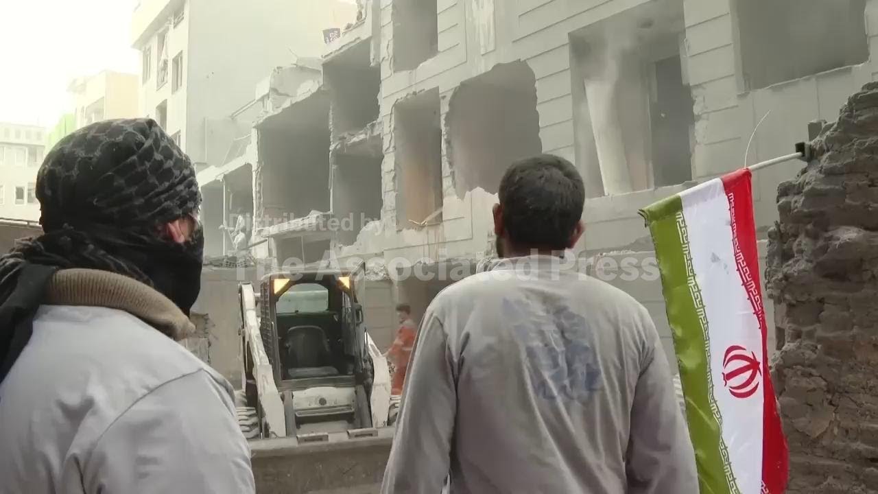 Residents and emergency workers clear strike damage in Tehran's Javadieh neighborhood
