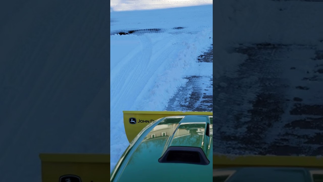 My new John Deere x730 pushing a little snow