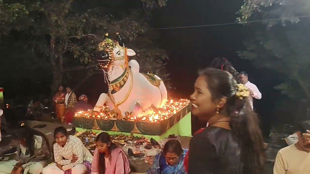 Devotees gathering at the brightly illuminated Bonaigarh Temple.