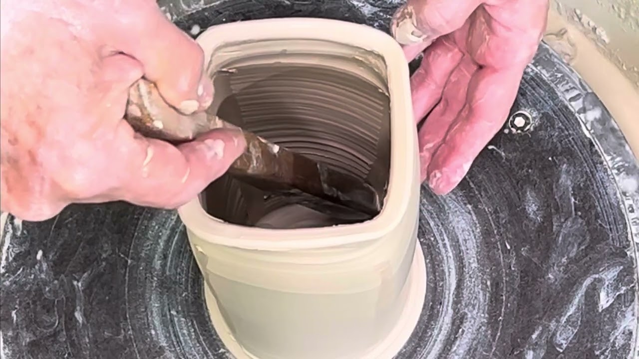 Squaring a thrown pottery cylinder to make the base of a lamp.