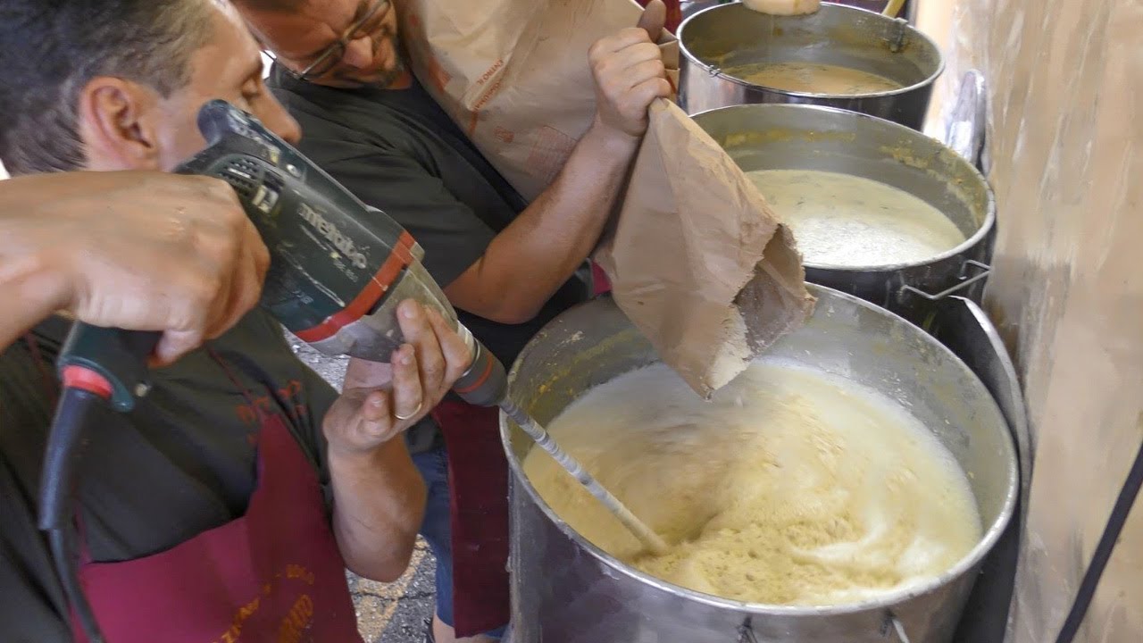 Italy Street Food. Cooking the  'Farinata', Chickpea Flour Pancake