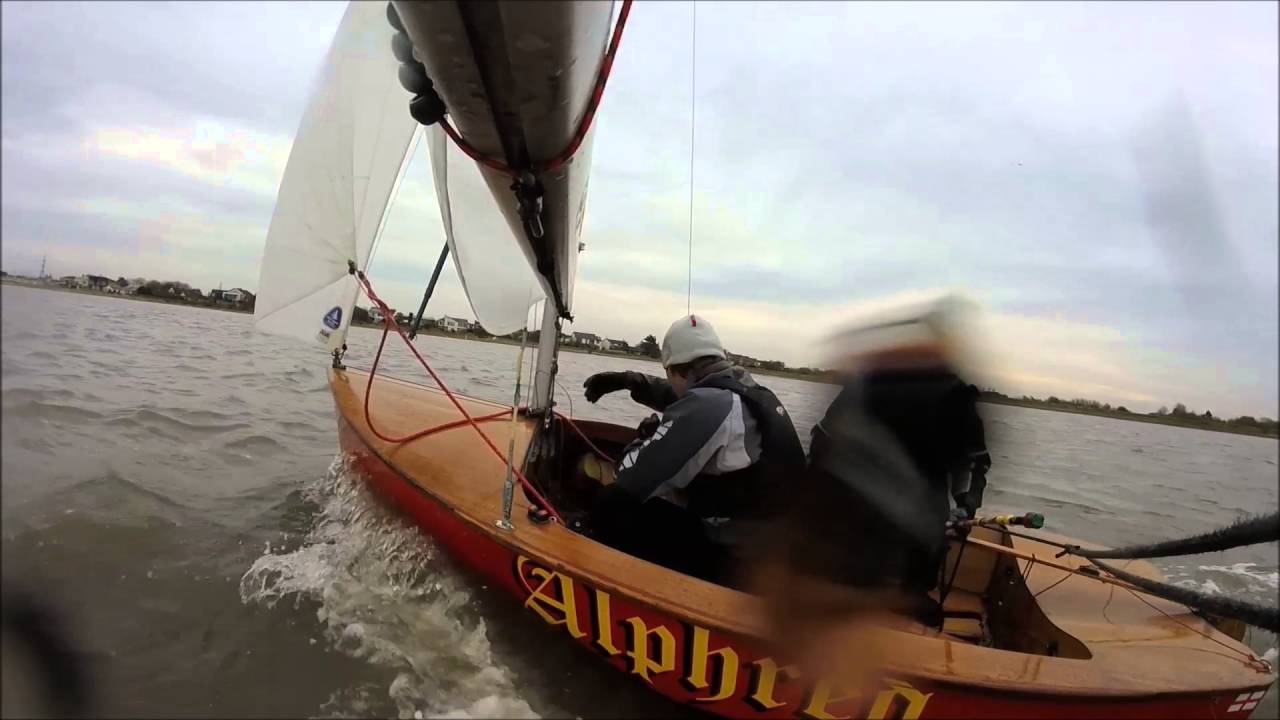 Sailing a Graduate dinghy in windy conditions! Lot's of spray and near misses