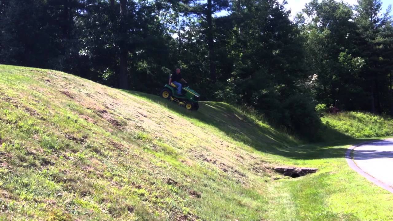 2013 John Deere X738 with front blade and 3-point hitch mowing steep hills