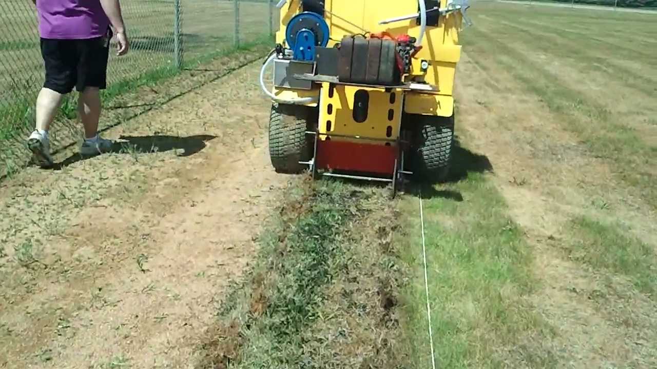 Baseball field warning track lip area renovation. Cutting sod.