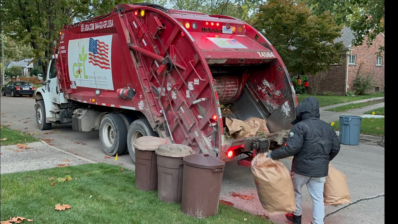 Red Priority Waste McNeilus Rear Loader Garbage Truck Packing Heavy Livonia Fall Yardwaste
