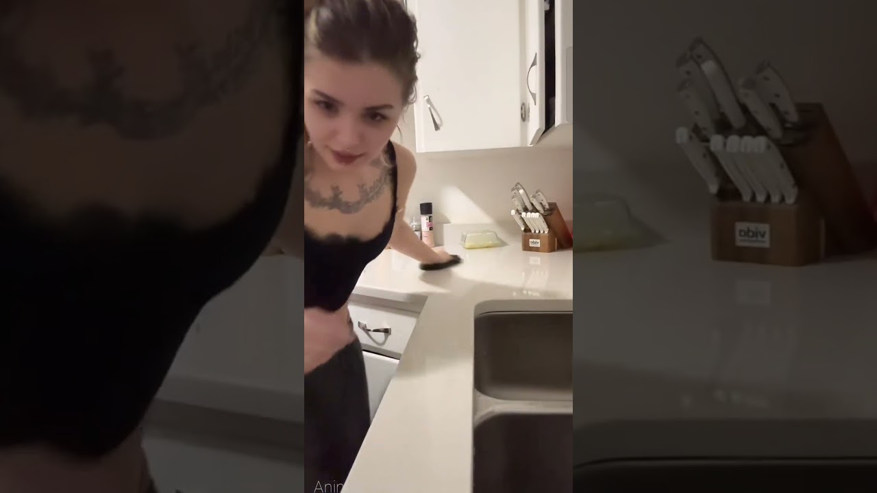 the routine of a beautiful girl busy cleaning the kitchen alone