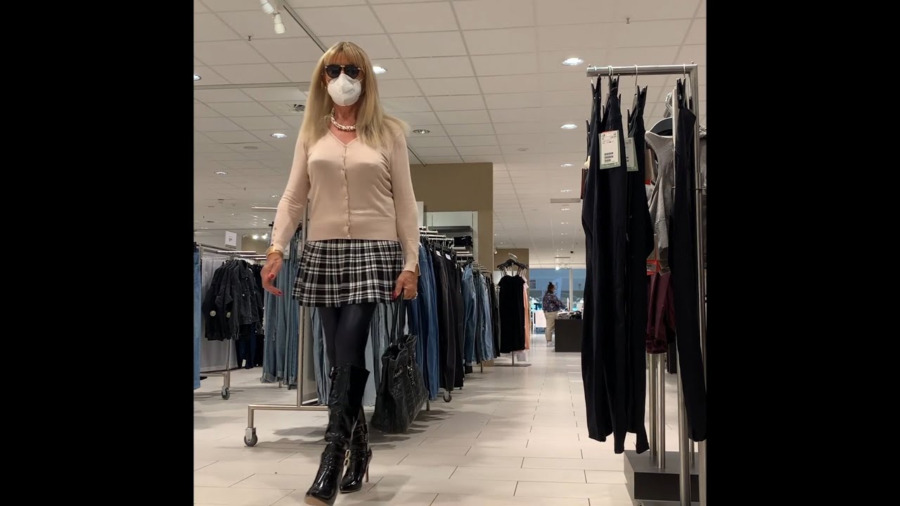 Crossdresser Stella in black knee high vinyl boots