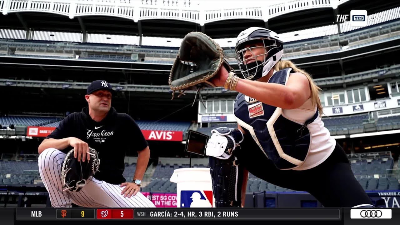 Mere on the Move: Meredith Marakovits gets a catching lesson from Tanner Swanson