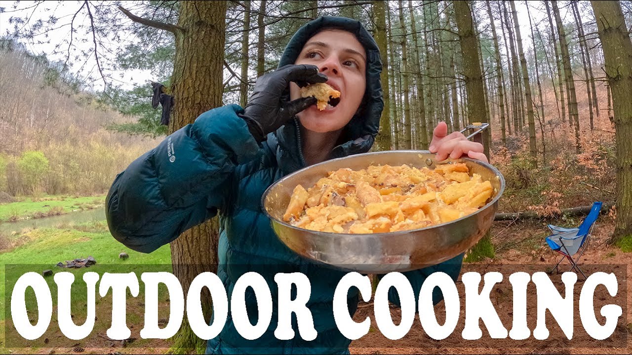 Heavy rain outdoor cooking on Soto Stormbreaker: fries, eggs, cheese, and salad