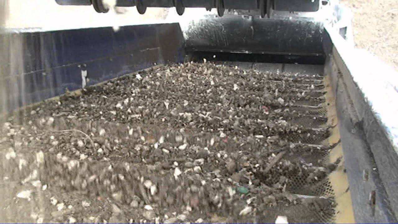 Mobile flip flow screen processing stockpiled skip waste fines.mpg