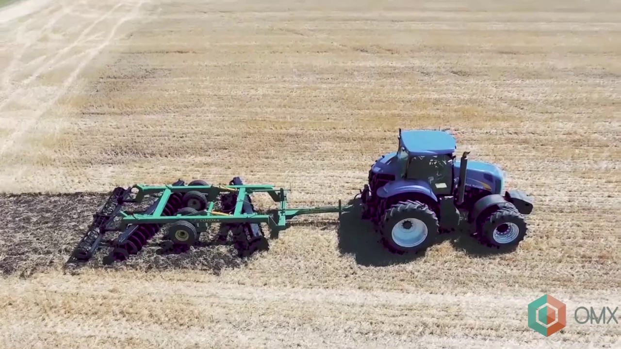 Дисковая борона Солоха БГР 4,2 и трактор New Holland - обзор, демонстрирует внешний вид.