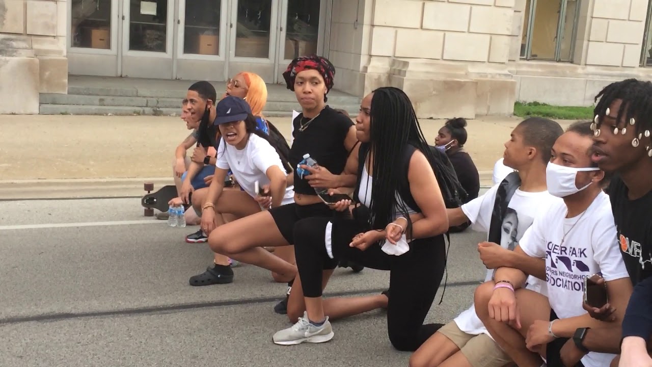 Young protesters, led by Nykeyla Henderson, stop in the middle of Second St. during a recent march.
